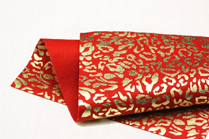 metallic gold leopard on red felt